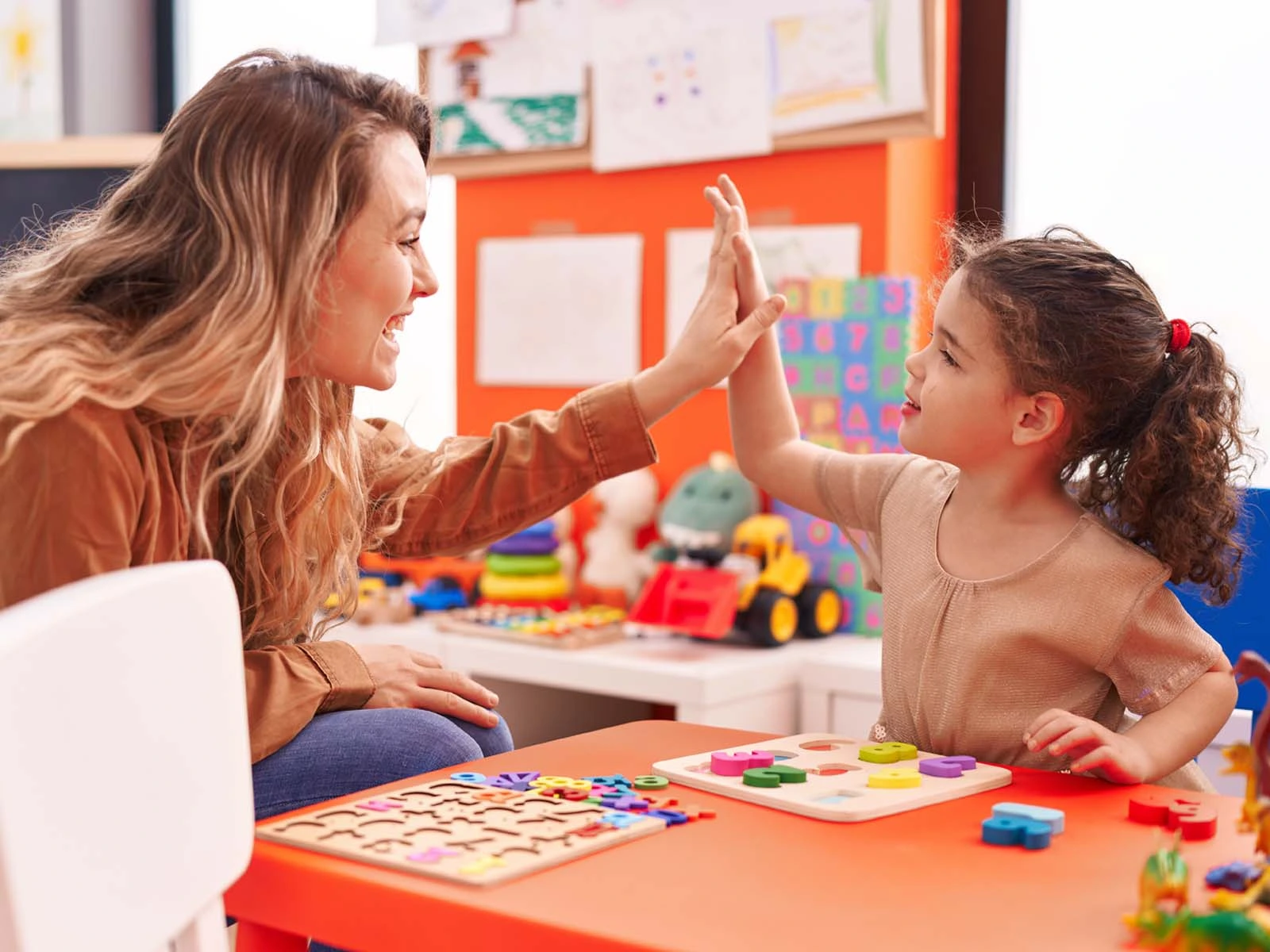 Child participating in an ABA therapy session with a certified therapist using interactive learning activities to improve communication, behavior, and social skills in Lahore.