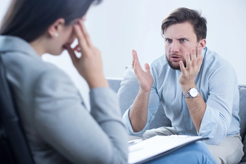 Man expressing anger and frustration during a professional anger management counseling session with a psychologist in Lahore, focusing on emotional regulation and healthy communication.