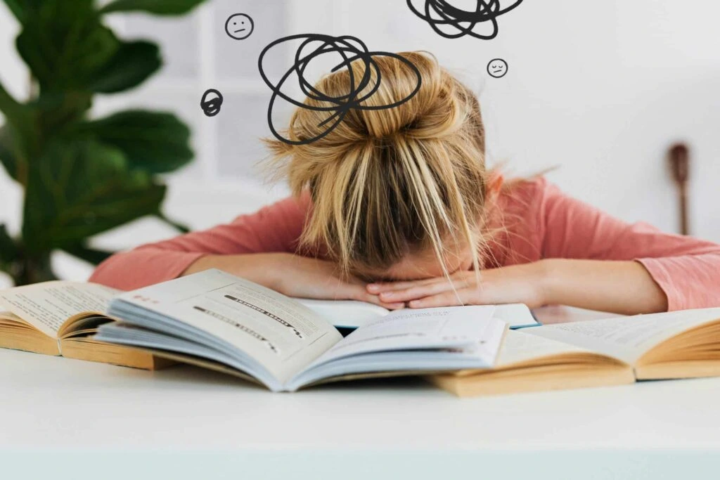 Young woman experiencing anxiety and emotional stress while studying, representing professional anxiety management therapy and psychological counseling services in Lahore.