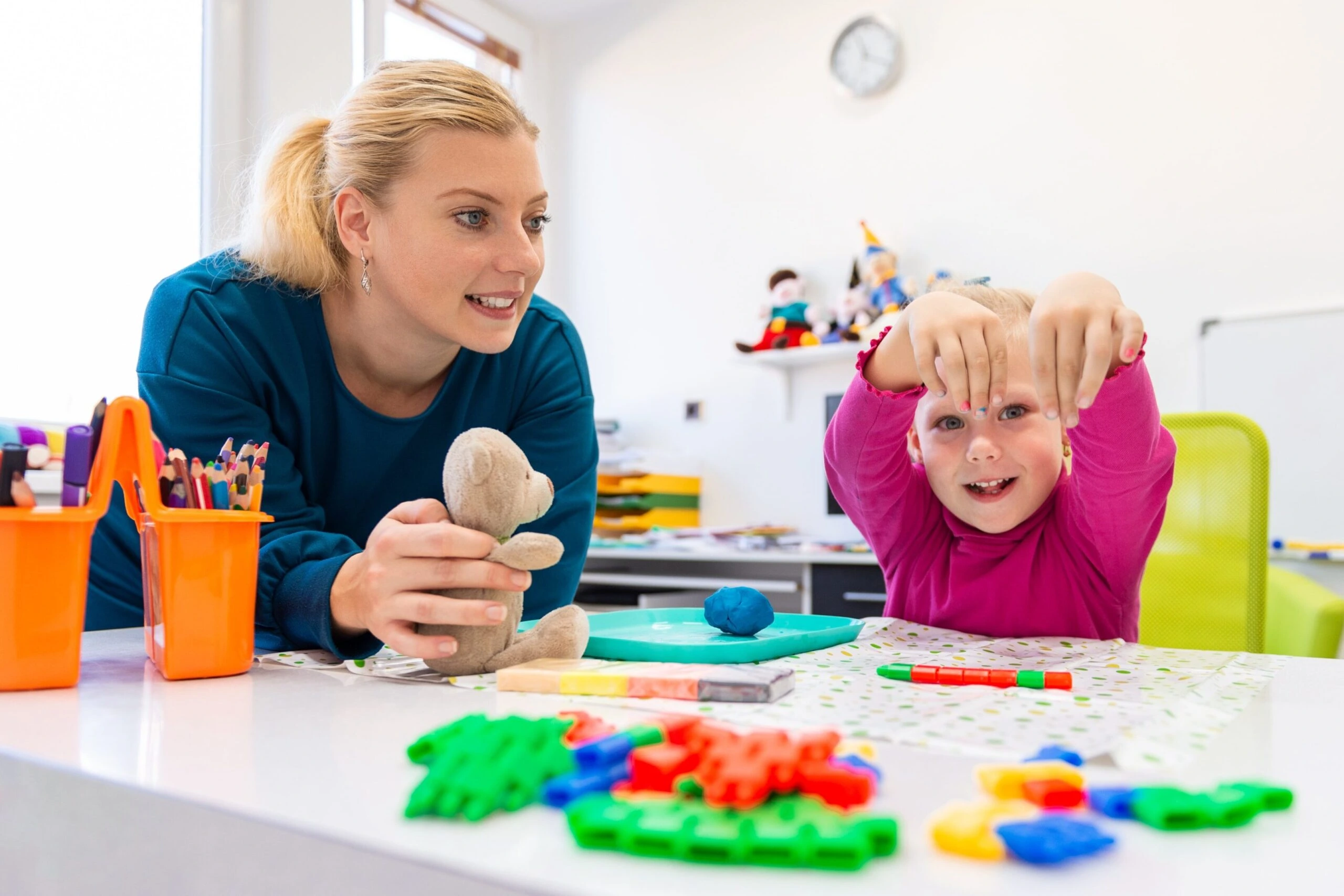 Occupational therapist helping a child improve fine motor skills, coordination, and daily living abilities through engaging therapy activities at Care & Cure Wellness Center in Lahore.