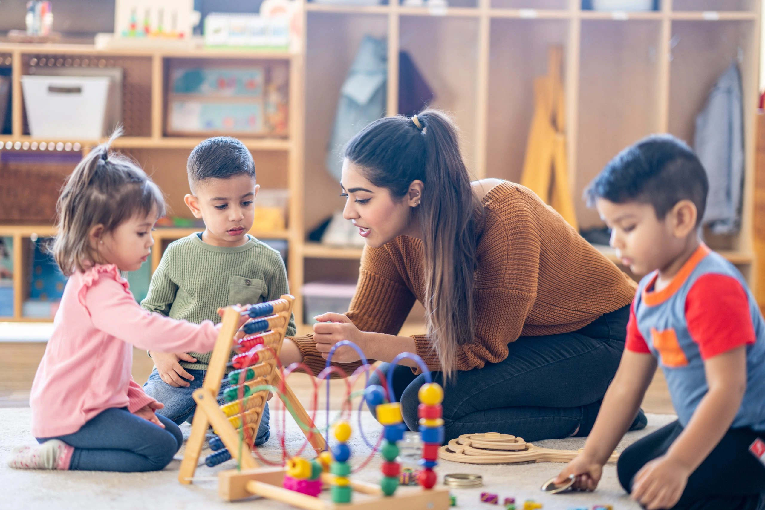 Children participating in a structured school readiness program designed to develop early learning, communication, social interaction, cognitive abilities, fine motor skills, and classroom readiness at Care & Cure Wellness Center in Lahore.