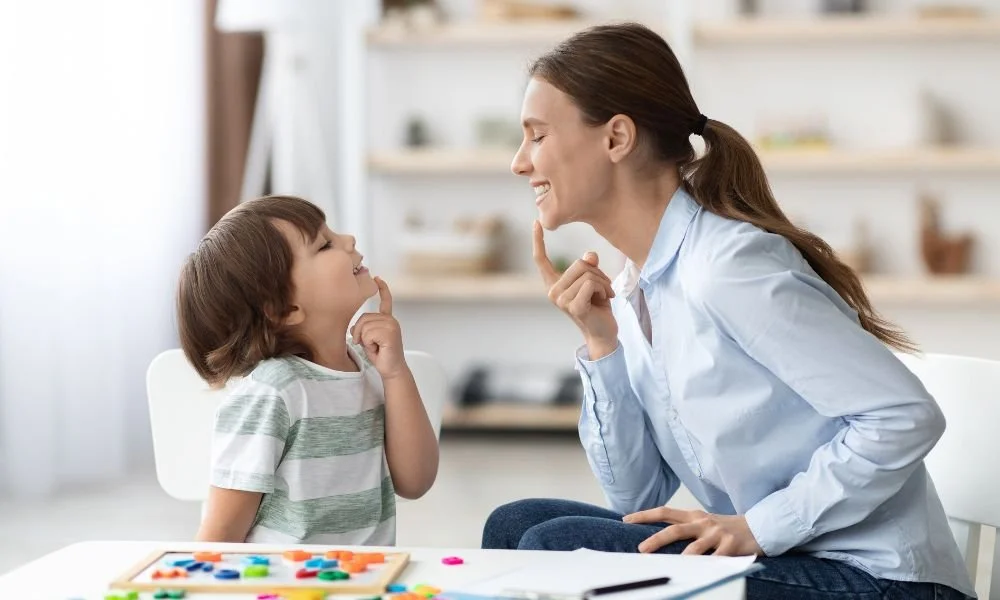 Speech therapist conducting a one-on-one speech therapy session with a young child to improve communication, language development, pronunciation, and speech skills at Care & Cure Wellness Center in Lahore.