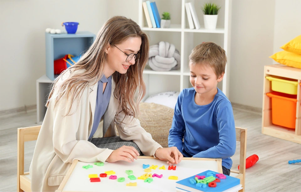 Professional ABA therapist working with a child using educational learning activities during an Applied Behavior Analysis (ABA) therapy session in Lahore.